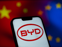 Chinese EV maker BYD logo is seen in a mobile device screen in this illsutration photo with Chinese and EU flags in the background in Warsaw...