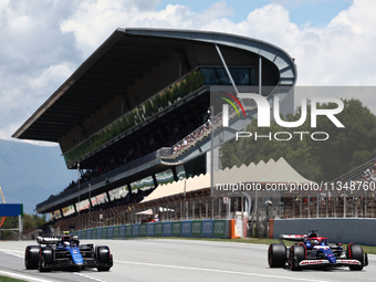 Logan Sargeant of Williams and Daniel Ricciardo of RB during first practice ahead of the Formula 1 Spanish Grand Prix at Circuit de Barcelon...