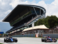 Logan Sargeant of Williams and Daniel Ricciardo of RB during first practice ahead of the Formula 1 Spanish Grand Prix at Circuit de Barcelon...