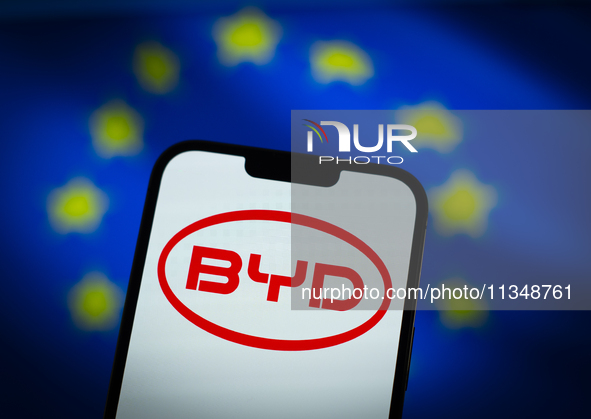 Chinese EV maker BYD logo is seen in a mobile device screen in this illsutration photo with Chinese and EU flags in the background in Warsaw...