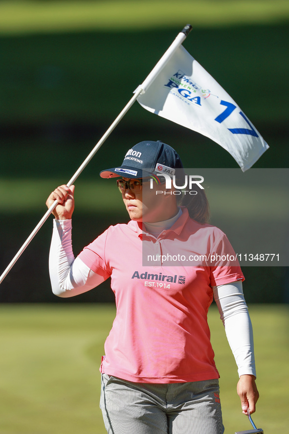 Nasa Hataoka of Japan holds the flag for the 17th hole during the first round of the KPMG Women's PGA Championship at Sahalee Country Club o...