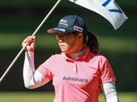 Nasa Hataoka of Japan holds the flag for the 17th hole during the first round of the KPMG Women's PGA Championship at Sahalee Country Club o...