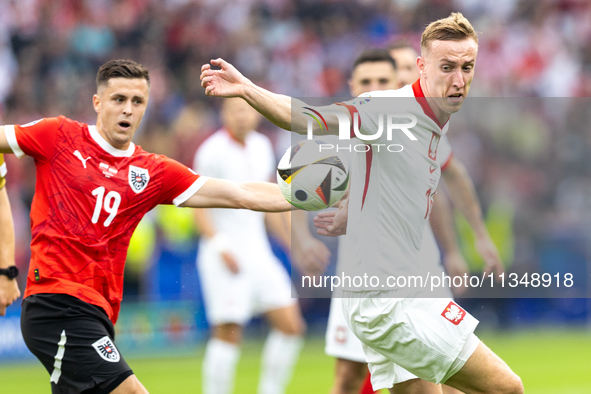 Christoph Baumgartner, Adam Buksa are playing during the UEFA Euro 2024 Group D match between Poland v Austria, at the Olympiastadion in Ber...