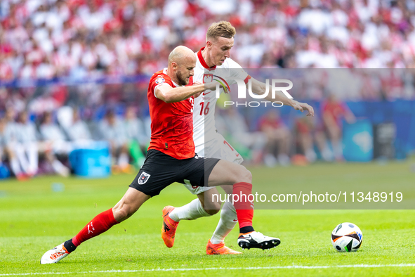 Gernot Trauner, Adam Buksa are playing during the UEFA Euro 2024 Group D match between Poland v Austria, at the Olympiastadion in Berlin,Ger...