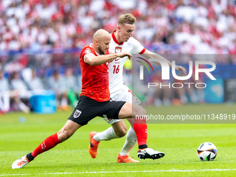 Gernot Trauner, Adam Buksa are playing during the UEFA Euro 2024 Group D match between Poland v Austria, at the Olympiastadion in Berlin,Ger...