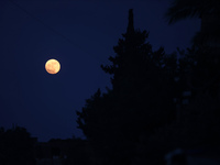 The full moon is rising over Deir al-Balah in the central Gaza Strip, on June 21, 2024, as the conflict is continuing in the Palestinian ter...