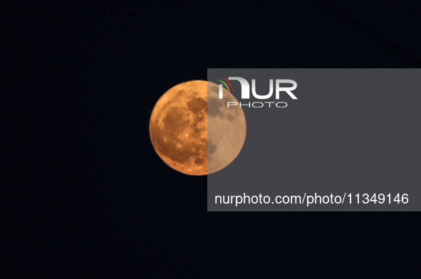 The full moon is rising over Deir al-Balah in the central Gaza Strip, on June 21, 2024, as the conflict is continuing in the Palestinian ter...