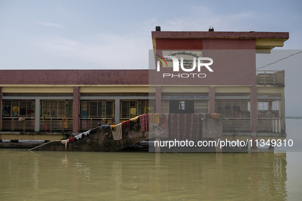 Local residents are gathering at a school building after floodwaters are inundating their homes in Gowainghat, Sylhet, Bangladesh, on June 2...