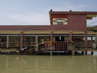 Local residents are gathering at a school building after floodwaters are inundating their homes in Gowainghat, Sylhet, Bangladesh, on June 2...