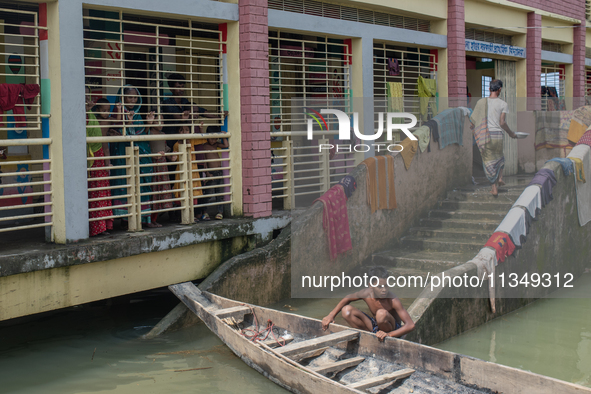 Local residents are gathering at a school building after floodwaters are inundating their homes in Gowainghat, Sylhet, Bangladesh, on June 2...