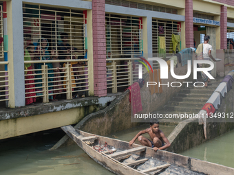 Local residents are gathering at a school building after floodwaters are inundating their homes in Gowainghat, Sylhet, Bangladesh, on June 2...