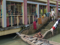 Local residents are gathering at a school building after floodwaters are inundating their homes in Gowainghat, Sylhet, Bangladesh, on June 2...