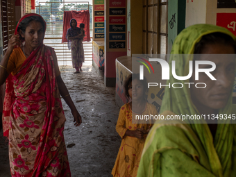 Local residents are gathering at a school building after floodwaters are inundating their homes in Gowainghat, Sylhet, Bangladesh, on June 2...