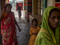 Local residents are gathering at a school building after floodwaters are inundating their homes in Gowainghat, Sylhet, Bangladesh, on June 2...