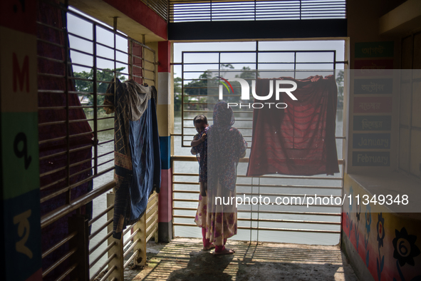 Local residents are gathering at a school building after floodwaters are inundating their homes in Gowainghat, Sylhet, Bangladesh, on June 2...