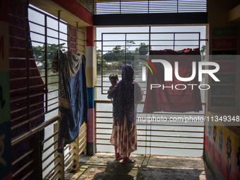 Local residents are gathering at a school building after floodwaters are inundating their homes in Gowainghat, Sylhet, Bangladesh, on June 2...