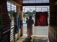 Local residents are gathering at a school building after floodwaters are inundating their homes in Gowainghat, Sylhet, Bangladesh, on June 2...