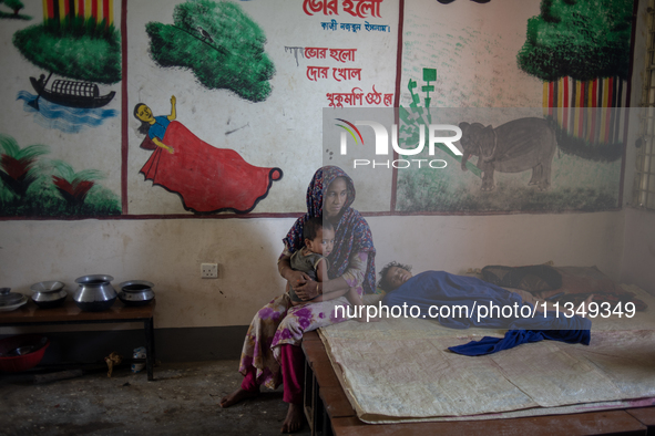 Local residents are gathering at a school building after floodwaters are inundating their homes in Gowainghat, Sylhet, Bangladesh, on June 2...