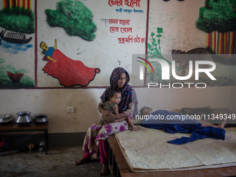 Local residents are gathering at a school building after floodwaters are inundating their homes in Gowainghat, Sylhet, Bangladesh, on June 2...