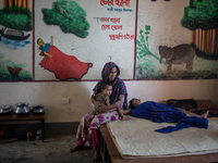 Local residents are gathering at a school building after floodwaters are inundating their homes in Gowainghat, Sylhet, Bangladesh, on June 2...