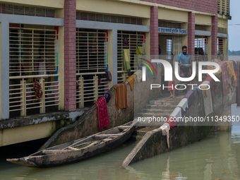 Local residents are gathering at a school building after floodwaters are inundating their homes in Gowainghat, Sylhet, Bangladesh, on June 2...