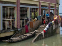 Local residents are gathering at a school building after floodwaters are inundating their homes in Gowainghat, Sylhet, Bangladesh, on June 2...