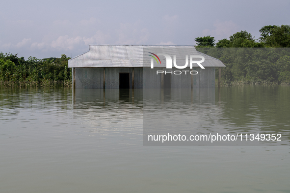 A house is being seen partially submerged after a flood in Gowainghat, Sylhet, Bangladesh, on Friday, June 21, 2024. 