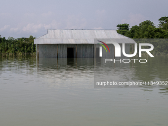 A house is being seen partially submerged after a flood in Gowainghat, Sylhet, Bangladesh, on Friday, June 21, 2024. (