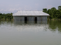 A house is being seen partially submerged after a flood in Gowainghat, Sylhet, Bangladesh, on Friday, June 21, 2024. (