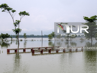 A partially submerged bridge is being seen after a flood in Gowainghat, Sylhet, Bangladesh, on June 21, 2024. (