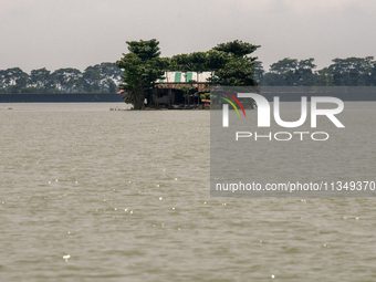 A house is being seen partially submerged after a flood in Gowainghat, Sylhet, Bangladesh, on Friday, June 21, 2024. (