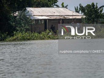 A man is sitting in his house after a flood in Gowainghat, Sylhet, Bangladesh, on June 21, 2024. (