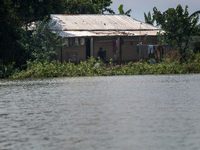 A man is sitting in his house after a flood in Gowainghat, Sylhet, Bangladesh, on June 21, 2024. (