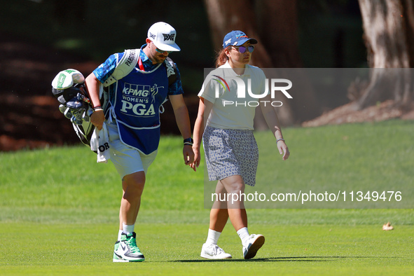 Mina Harigae of Monterey, California walks with her caddie to the 15th green during the second round of the KPMG Women's PGA Championship at...