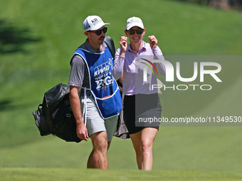 Sarah Schmelzel of the United States interacts with her caddy on the 18th hole during Day Two of the KPMG Women's PGA Championship at Sahale...