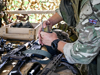 A soldier of a reconnaissance unit of the 128th separate mountain assault brigade of the Zakarpattia region is preparing for a firearms trai...