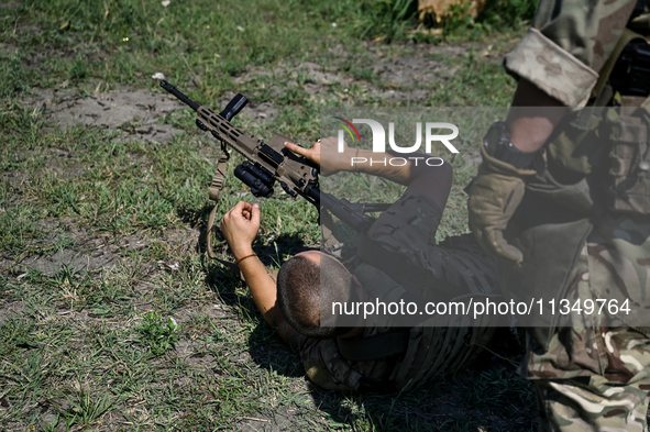 A combat squad of a reconnaissance unit of the 128th separate mountain assault brigade of the Zakarpattia region is being seen before the st...