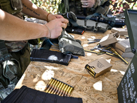 A soldier of a reconnaissance unit of the 128th separate mountain assault brigade of the Zakarpattia region is getting ready for a firearms...