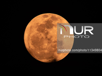 The Strawberry Moon is being seen in Ungaran, Central Java Province, Indonesia, on June 21, 2024. (