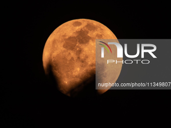 The Strawberry Moon is being seen in Ungaran, Central Java Province, Indonesia, on June 21, 2024. (