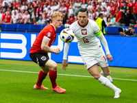 Nicolas Seiwald, Piotr Zielinski are playing during the UEFA Euro 2024 Group D match between Poland v Austria, at the Olympiastadion in Berl...