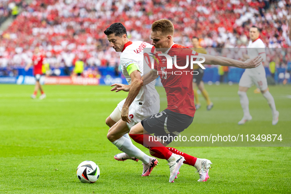 Robert Lewandowski, Philipp Lienhart are playing during the UEFA Euro 2024 Group D match between Poland v Austria, at the Olympiastadion in...