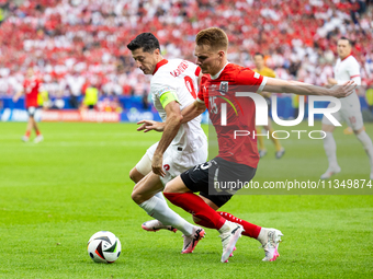 Robert Lewandowski, Philipp Lienhart are playing during the UEFA Euro 2024 Group D match between Poland v Austria, at the Olympiastadion in...