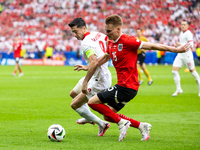 Robert Lewandowski, Philipp Lienhart are playing during the UEFA Euro 2024 Group D match between Poland v Austria, at the Olympiastadion in...