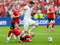 Nicolas Seiwald, Robert Lewandowski are playing during the UEFA Euro 2024 Group D match between Poland v Austria, at the Olympiastadion in B...