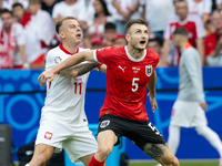 Kamil Grosicki, Stefan Posch are playing during the UEFA Euro 2024 Group D match between Poland v Austria, at the Olympiastadion in Berlin,G...