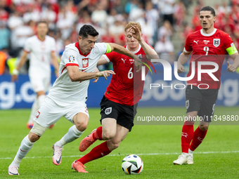 Robert Lewandowski, Nicolas Seiwald are playing during the UEFA Euro 2024 Group D match between Poland v Austria, at the Olympiastadion in B...