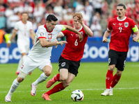 Robert Lewandowski, Nicolas Seiwald are playing during the UEFA Euro 2024 Group D match between Poland v Austria, at the Olympiastadion in B...