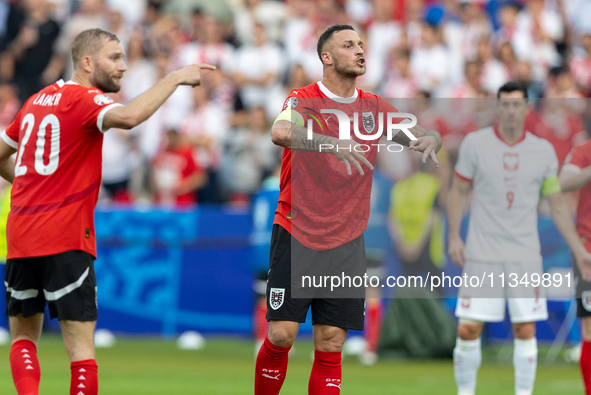 Konrad Laimer, Marko Arnautovic  are playing during the UEFA Euro 2024 Group D match between Poland v Austria, at the Olympiastadion in Berl...