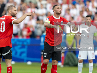 Konrad Laimer, Marko Arnautovic  are playing during the UEFA Euro 2024 Group D match between Poland v Austria, at the Olympiastadion in Berl...